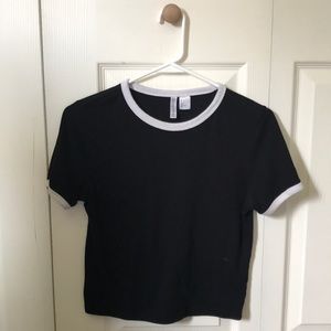 black top with white sleeves on edge.